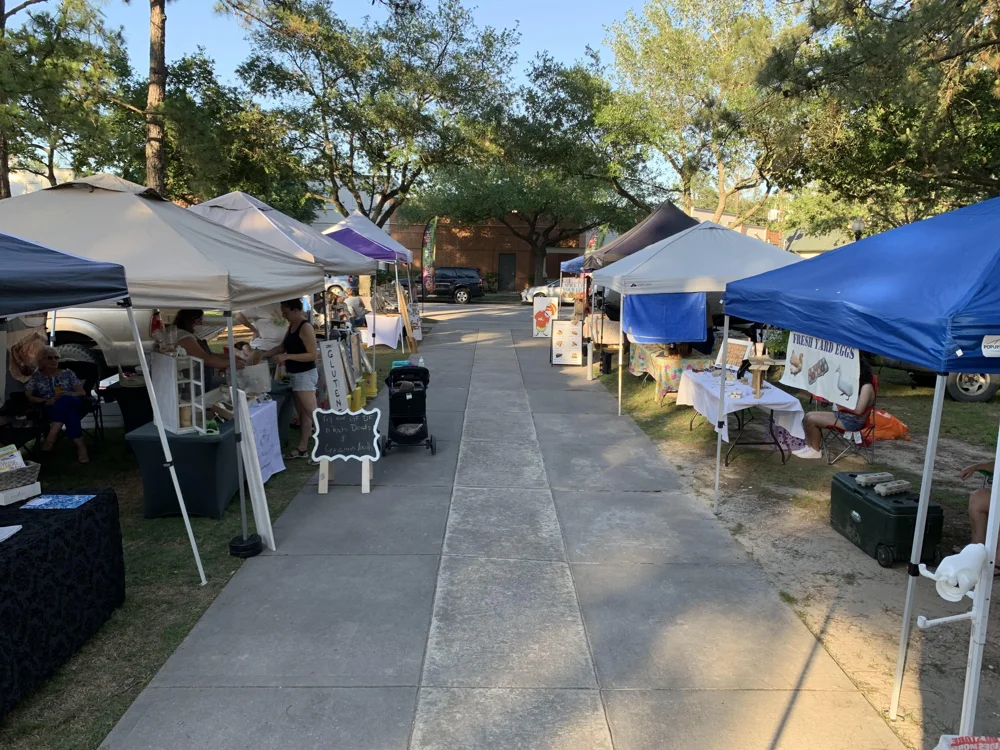 Bakery and egg stalls lining a Kingwood Farmers Market walkway